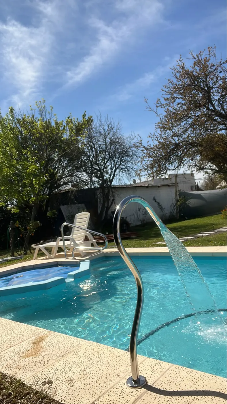 Piscina con cascada de acero inoxidable en un jardín